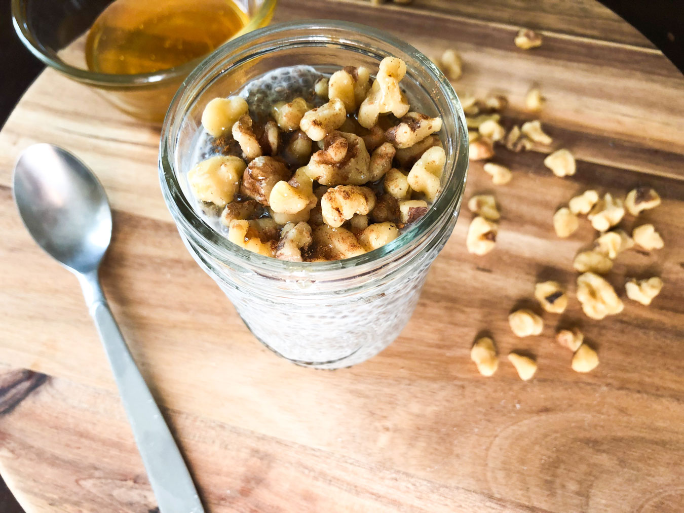 Chia seed pudding in a mason jar topped with honey and walnuts