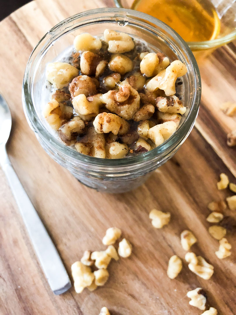 Chia seed pudding in a mason jar topped with honey and walnuts