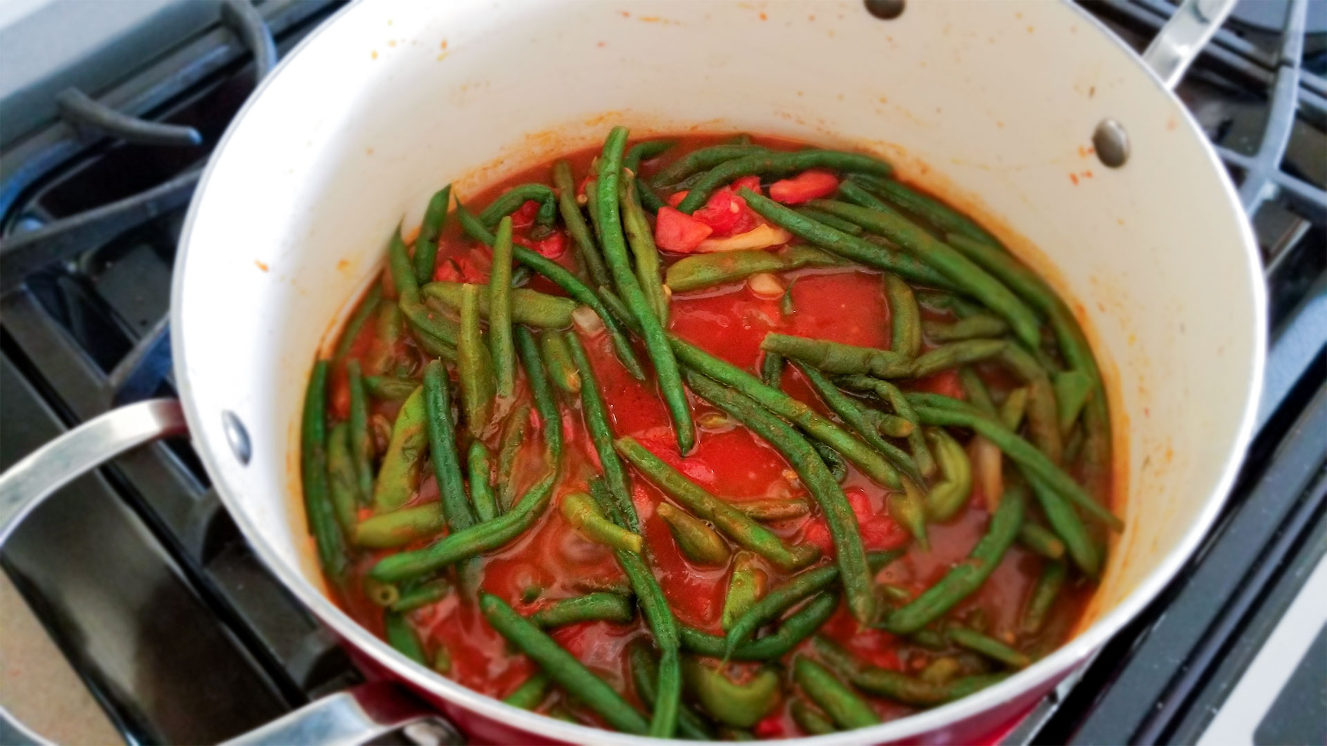 Green beans in tomato sauce in a stockpot