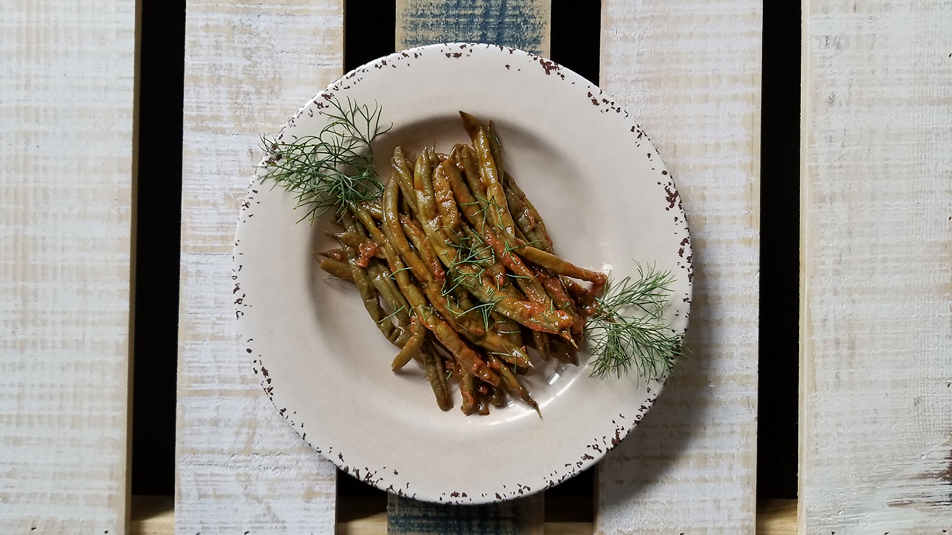 Greek Green Beans in Tomato Sauce n a bowl with dill