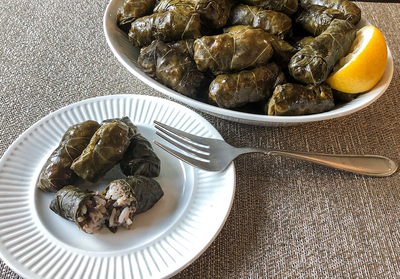 stuffed grape leaves in a bowl and on a plate