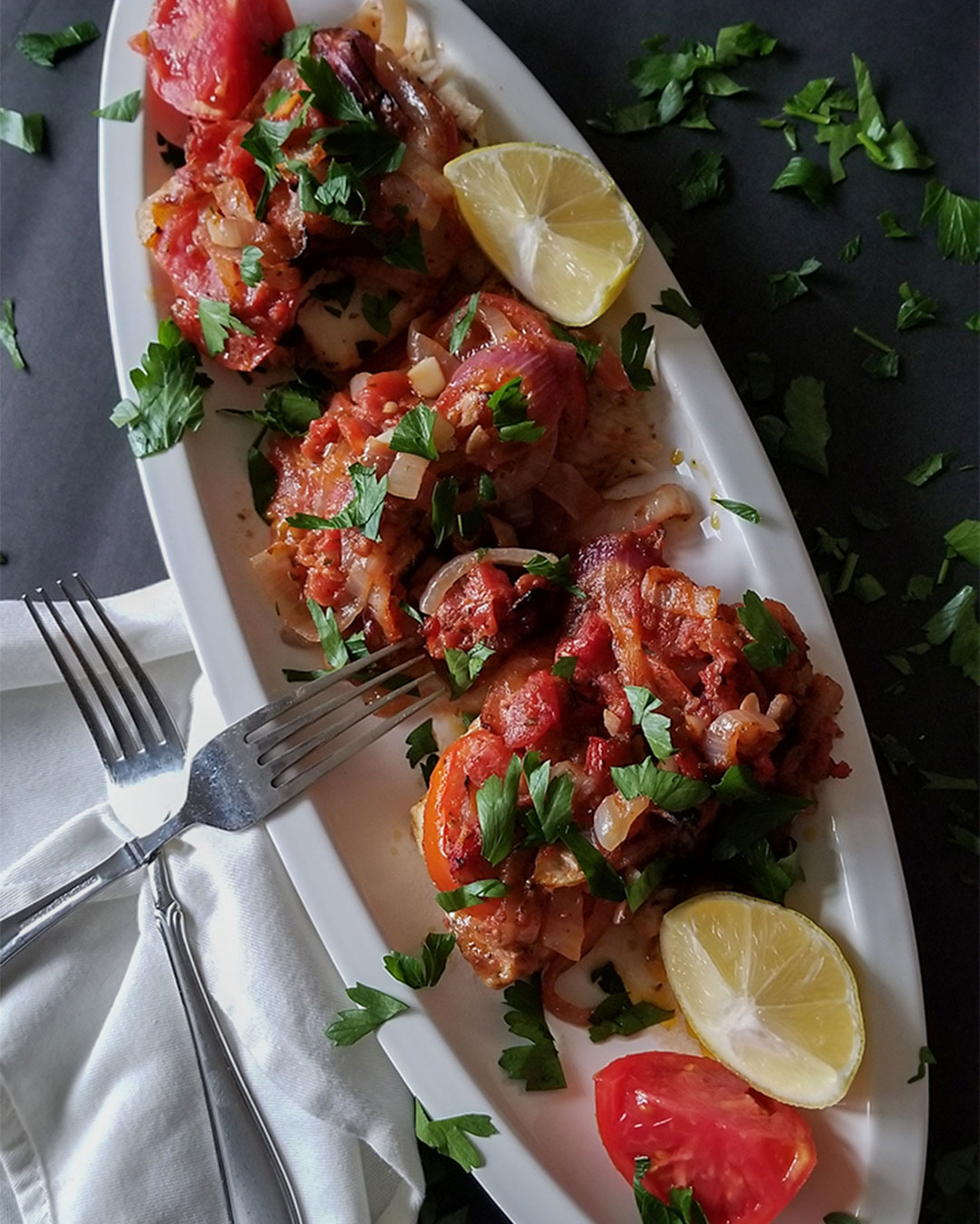 Fish Plaki (oven baked fish) on a serving plate