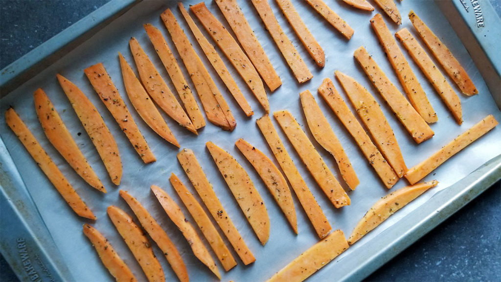 sweet potatoes in a single layer on a lined baking sheet