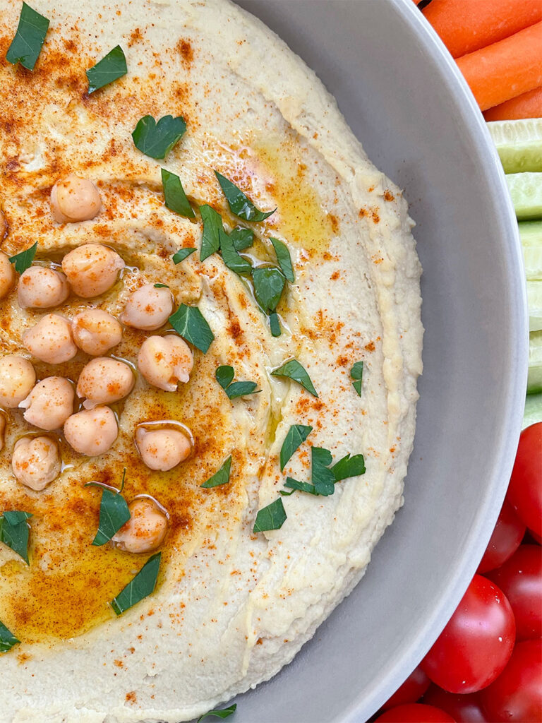homemade hummus topped with olive oil and parsley