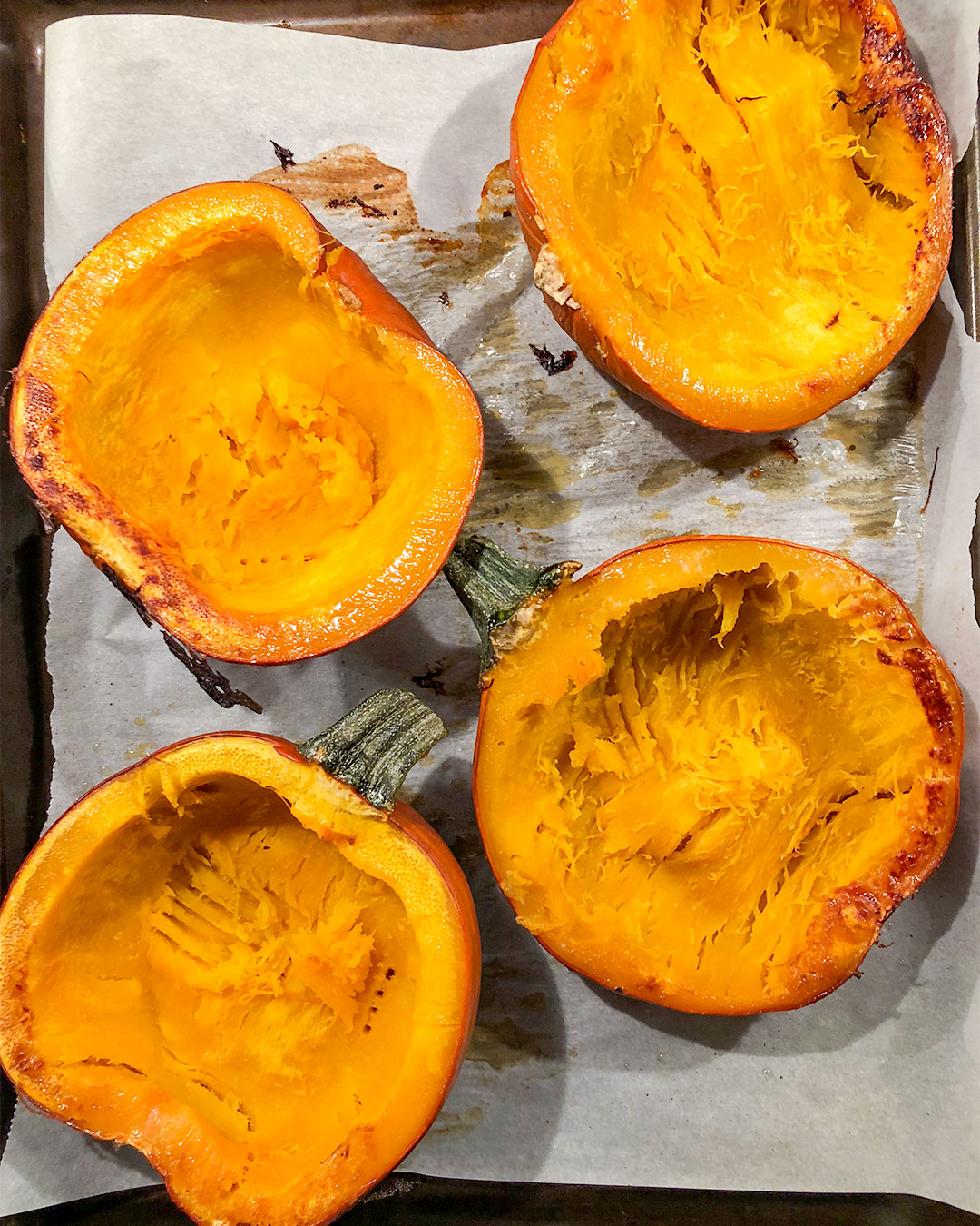 pumpkin pie pumpkins on a baking sheet after cooking in the oven