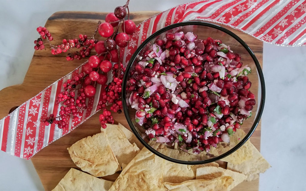 Pomegranate Feta Salsa in a bowl with pita chips on the side