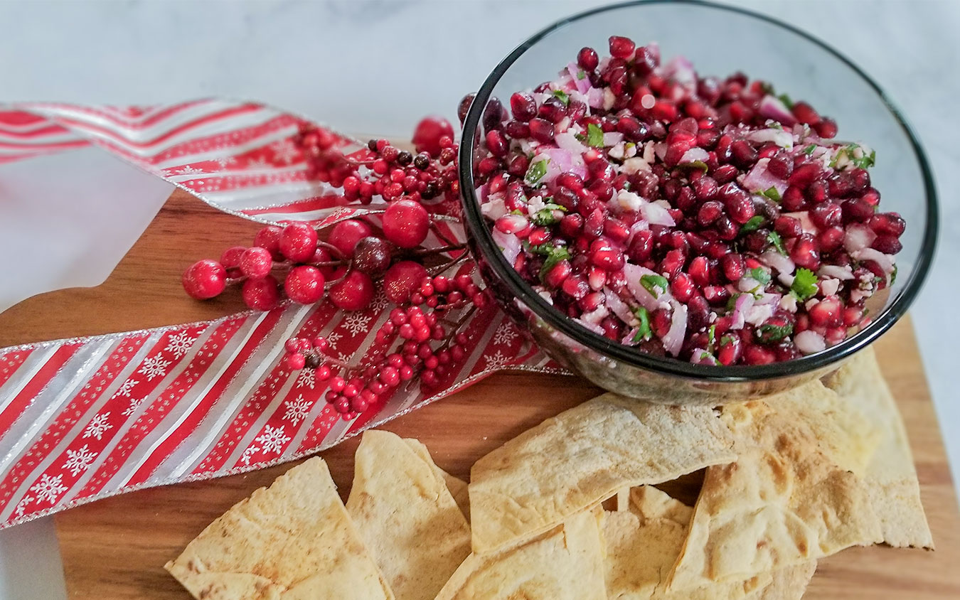 Pomegranate Feta Salsa in a bowl with pita chips on the side