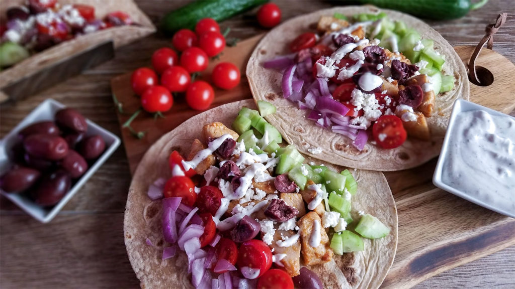 Grecian tacos topped with feta cheese and tzatziki sauce