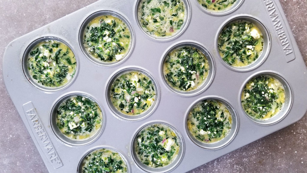 Pre-cooked Spanakopita Egg Cups in a muffin tin