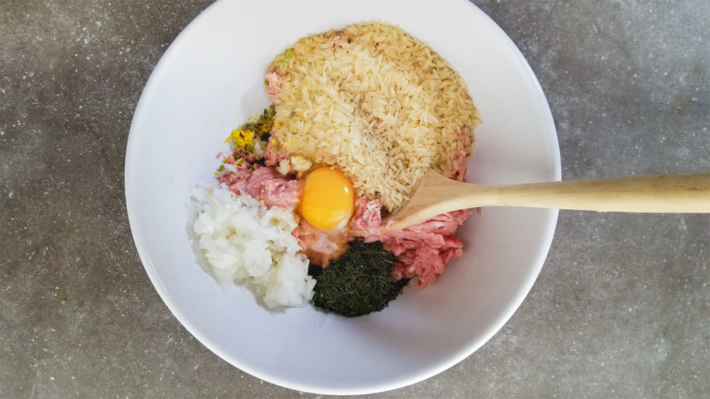 Youvarlakia meatball ingredients in a bowl