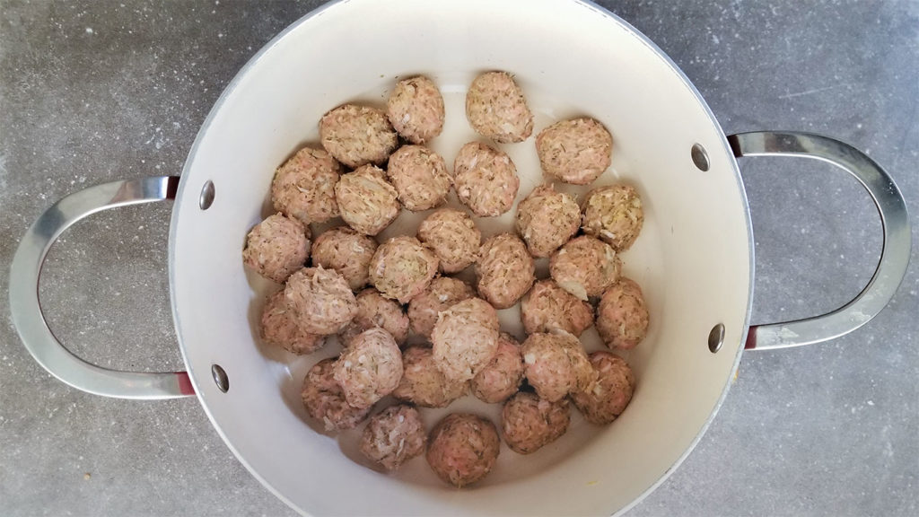 Youvarlakia meatballs in a stockpot