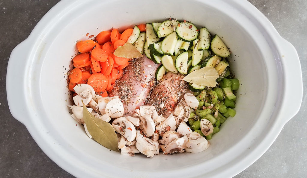 Crock Pot Italian Spiced Chicken Orzo Soup ingredients in a crocpot before cooking