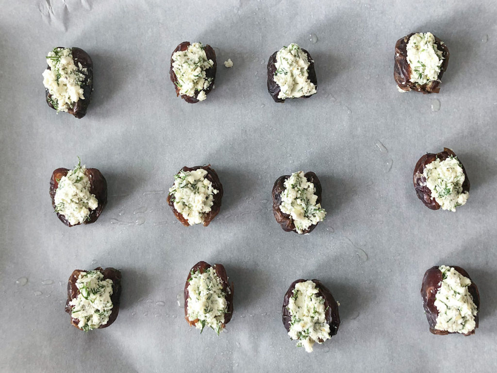 Feta Stuffed Dates arranged on parchment paper