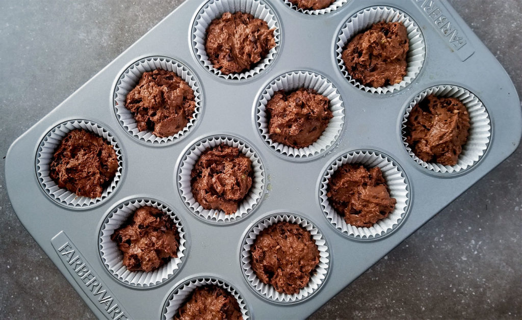 chocolate muffin mix in a muffin tin