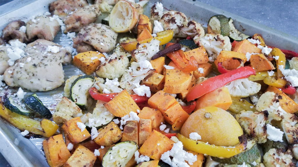 baked vegetables and chicken on a sheet pan