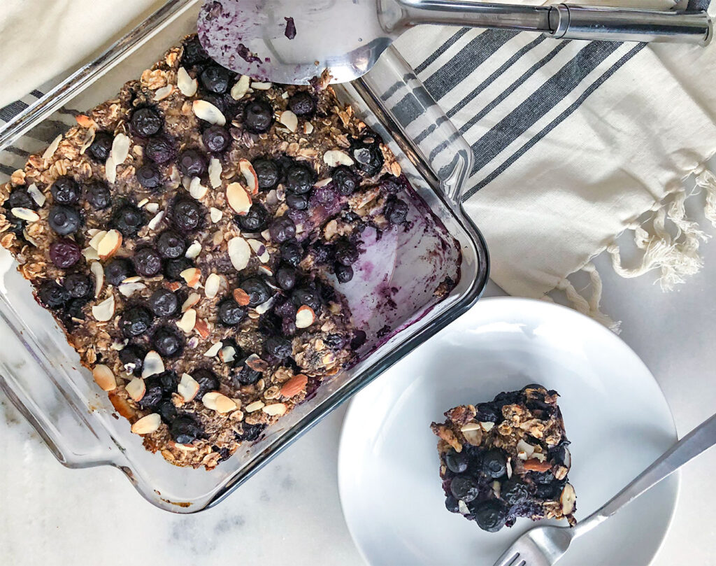 Baked Oatmeal in  baking dish with a square piece cut out on a plate