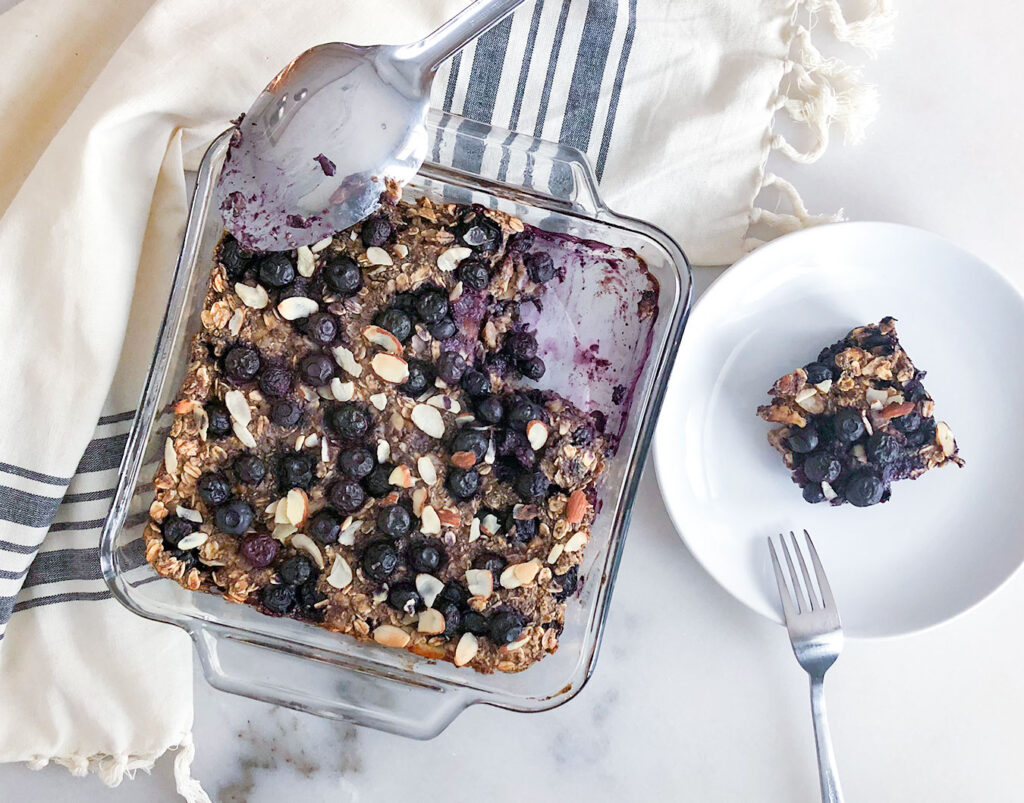 Baked Oatmeal in  baking dish with a square piece cut out on a plate