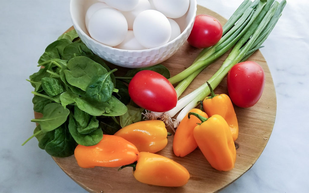 Greek Breakfast Wrap ingredients, spinach, eggs, peppers, tomatoes and green onion