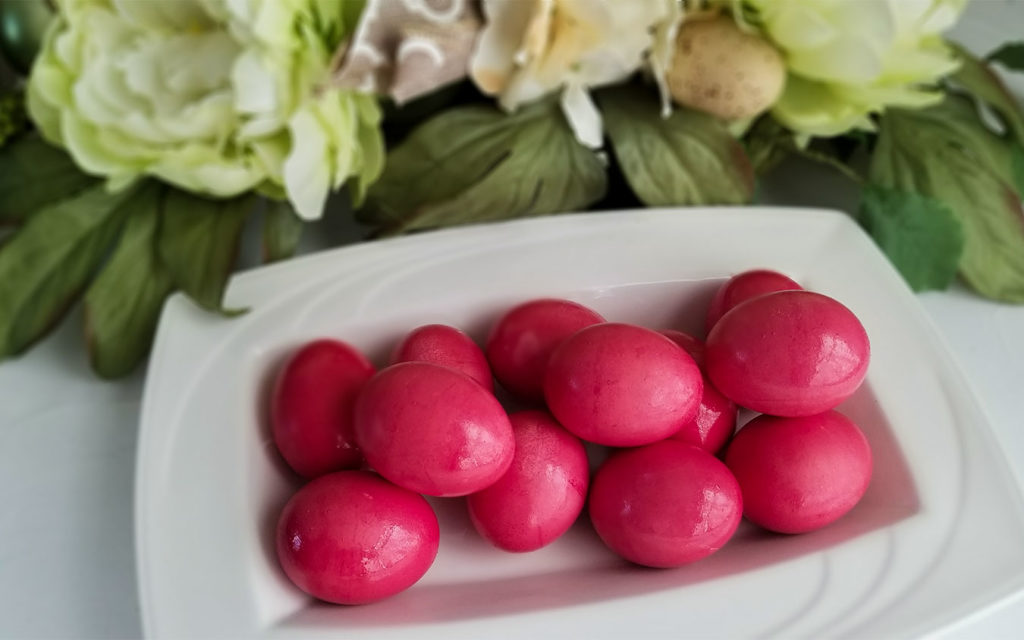 Red dyed Greek Easter eggs on a platter