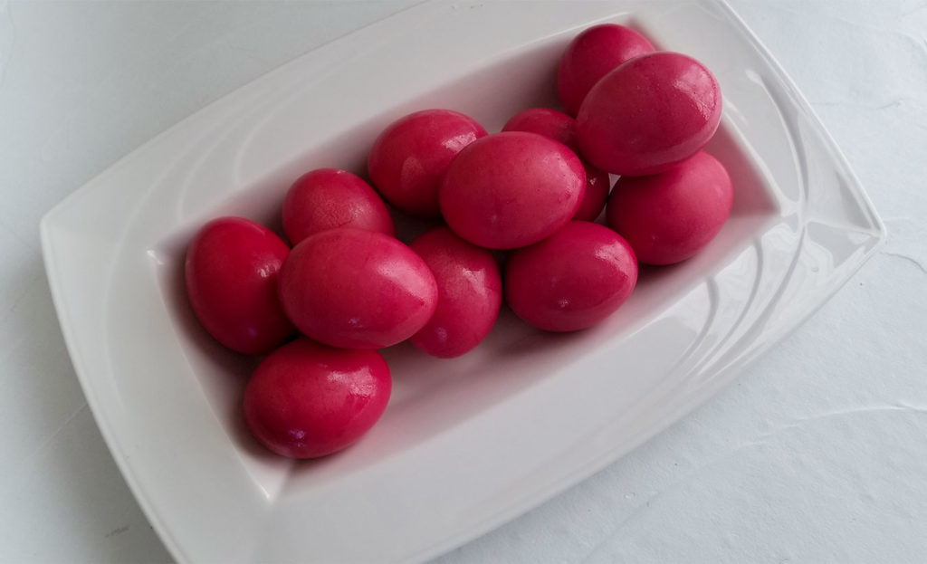 Red dyed Easter eggs on a platter