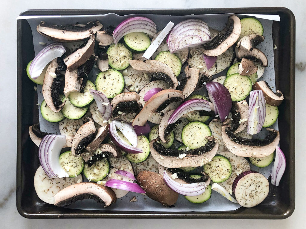 Vegetables seasoned on a baking sheet