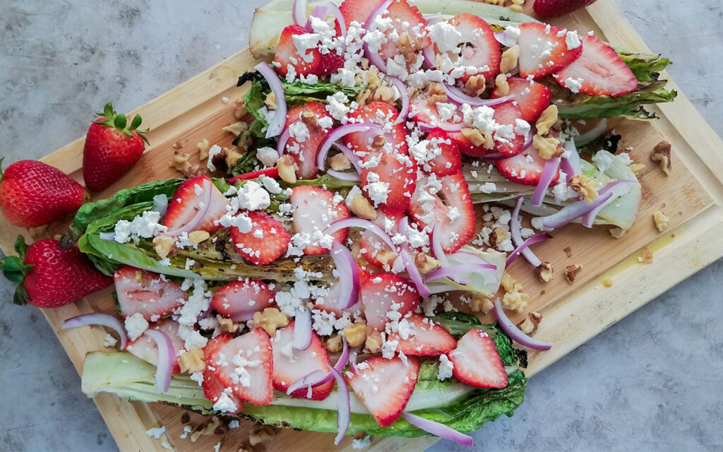 Grilled Romaine Strawberry Salad topped with walnuts and feta cheese