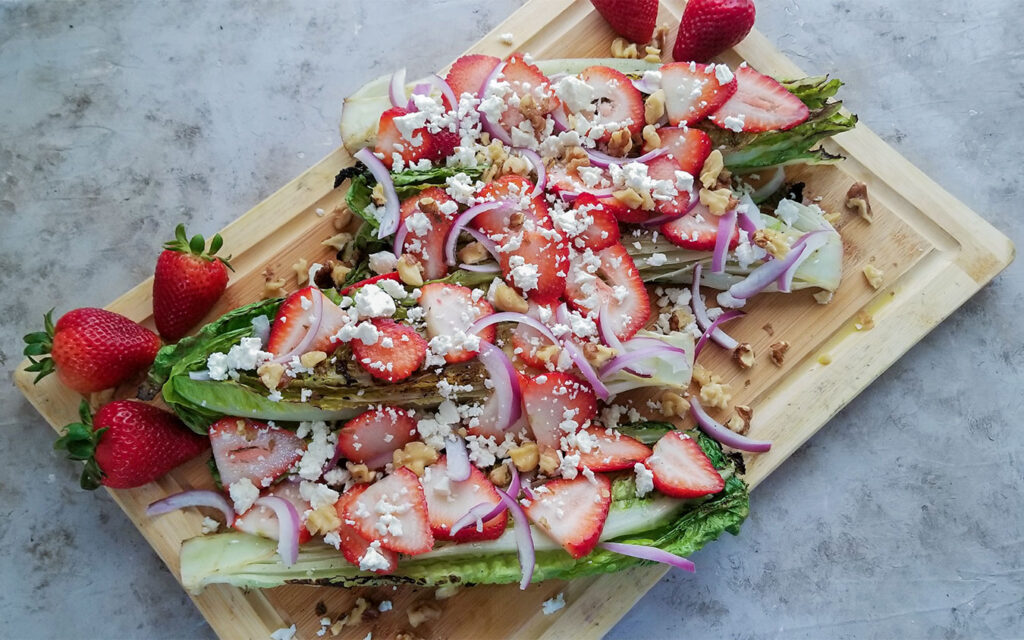 Grilled Romaine Strawberry Salad topped with walnuts and feta cheese