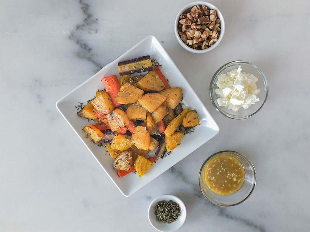 Roasted Golden Beet Salad on a plate with toppings in small bowls