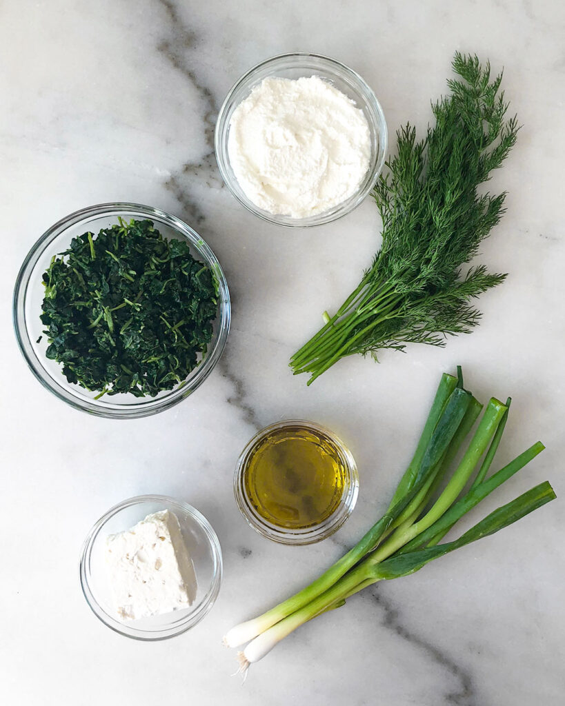 spanakopita filling ingredients in individual bowls