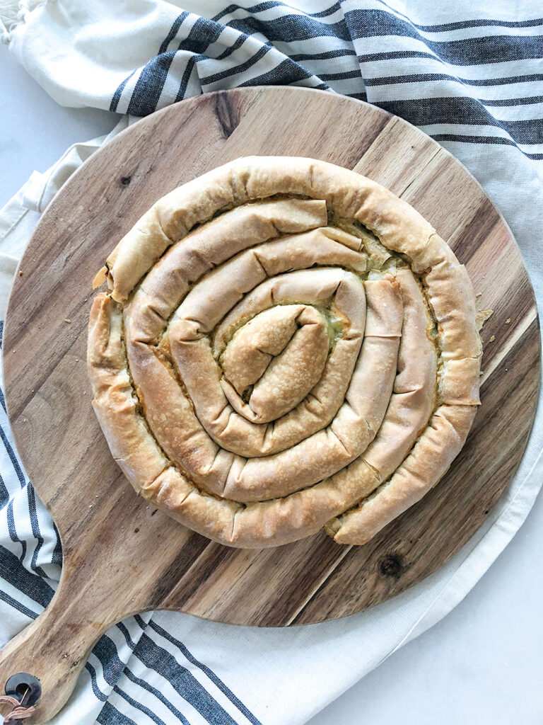 cooked spanakopita swirl on a cutting board