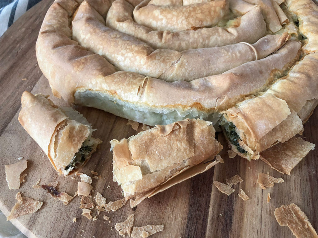 cooked spanakopita swirl on a cutting board