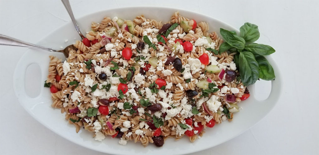 Greek pasta salad in a serving dish