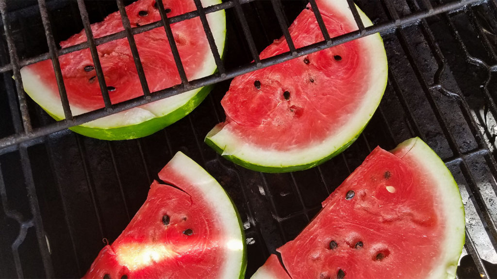 watermelon slices cooking on a grill