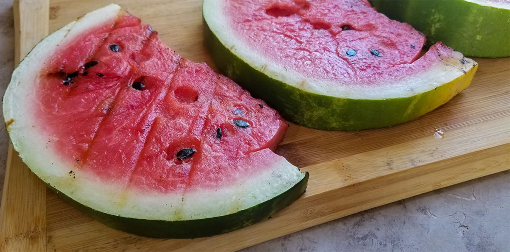 grilled watermelon slices on a cutting board