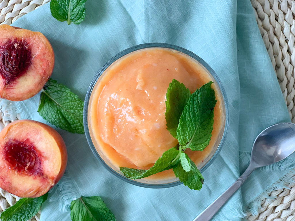 Peach Sorbet in a cup with mint garnish