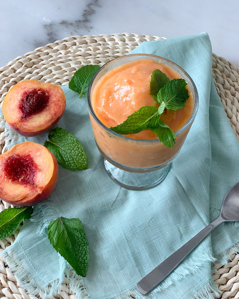 Peach Sorbet in a cup with mint garnish