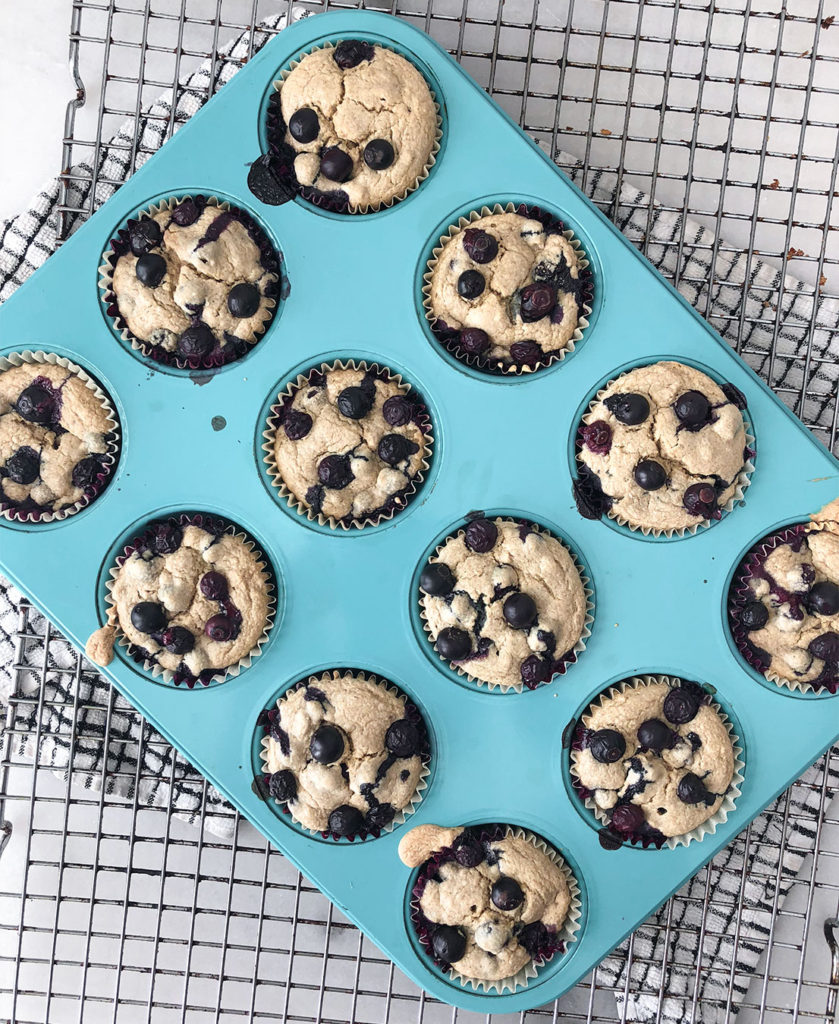 Blueberry Muffins in a muffin tin on a cooling rack