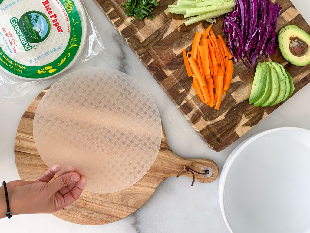 rice paper wrappers with Vegetable Summer Rolls ingredients on a cutting board
