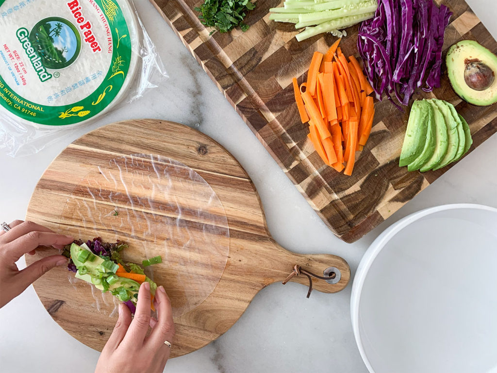 rice paper wrappers filled with Vegetable Summer Rolls ingredients on a cutting board