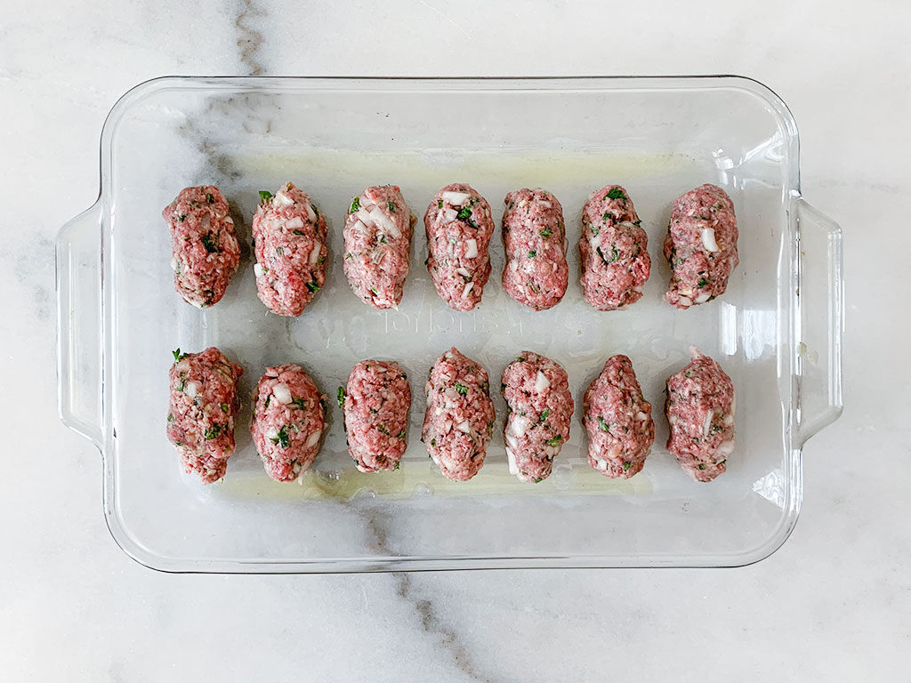 formed meatballs in a baking dish coated with olive oil