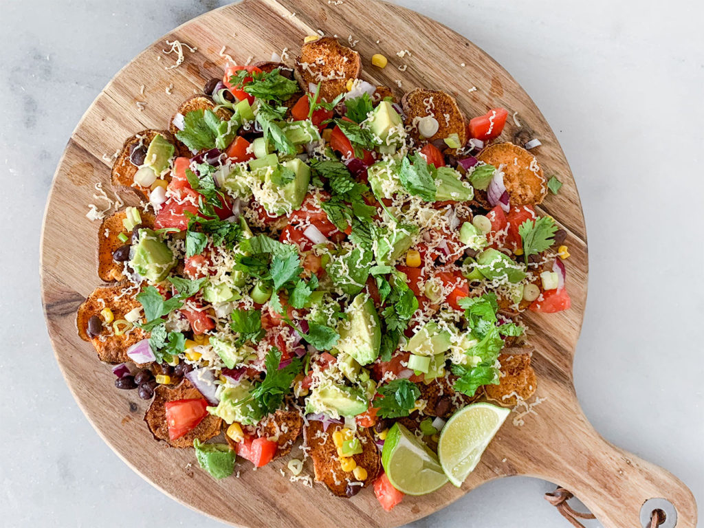 Sweet Potato Nachos assembled on a cutting board