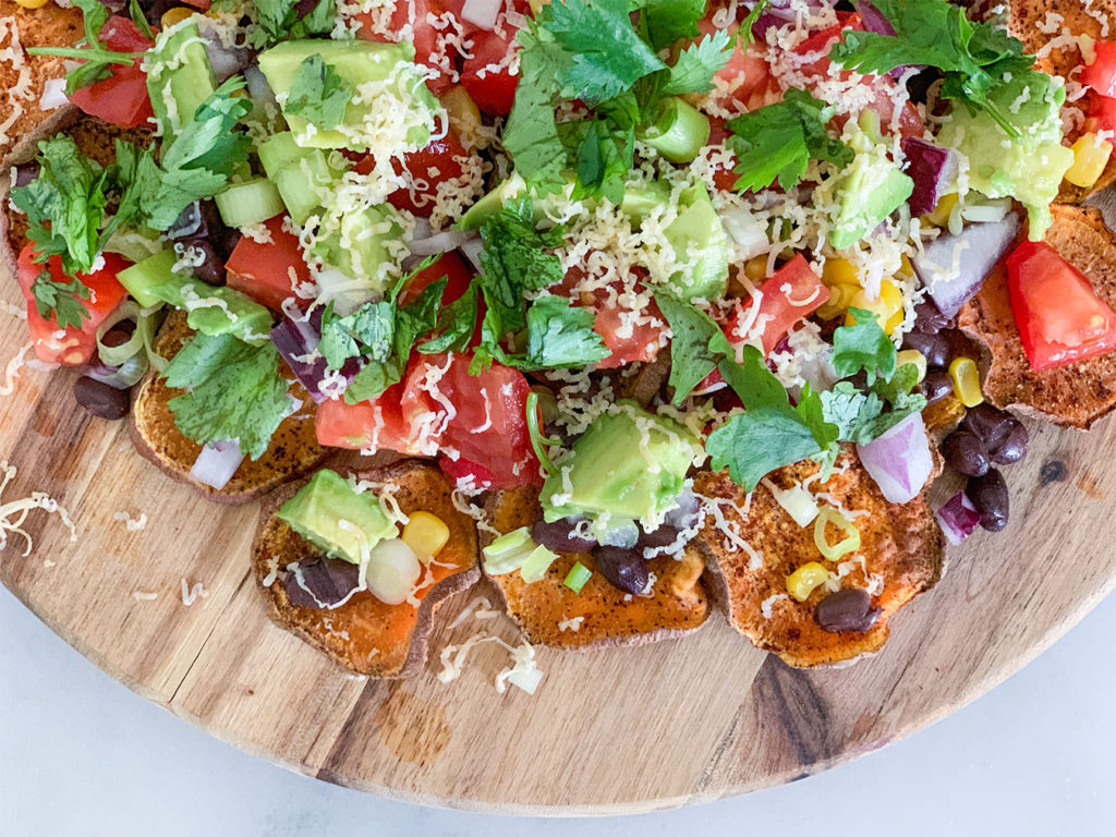 Sweet Potato Nachos assembled on a cutting board