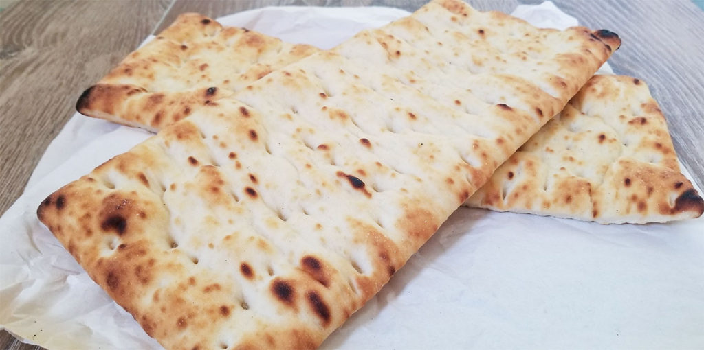 focaccia bread on parchment paper