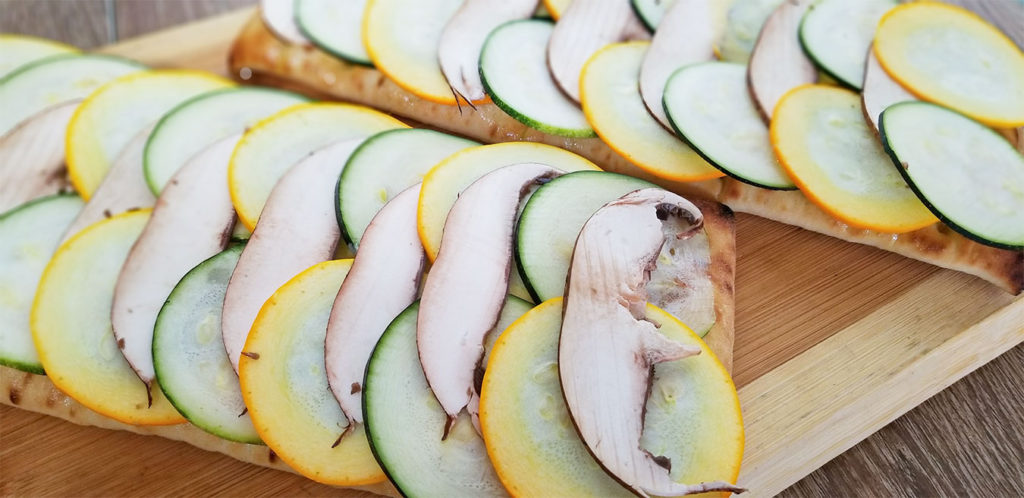 focaccia bread with layers of squash and mushrooms