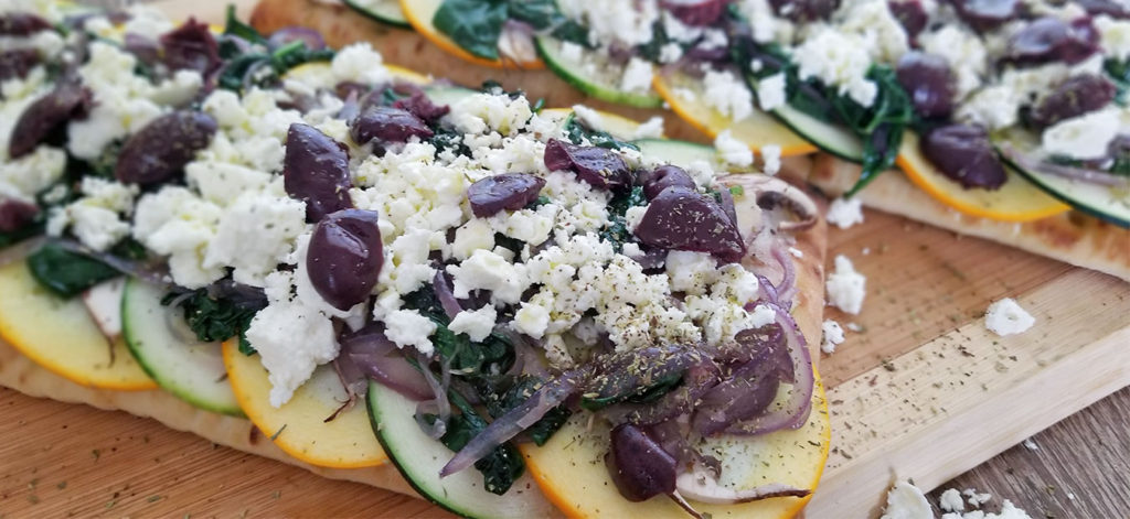 Mediterranean Focaccia Pizza on a cutting board