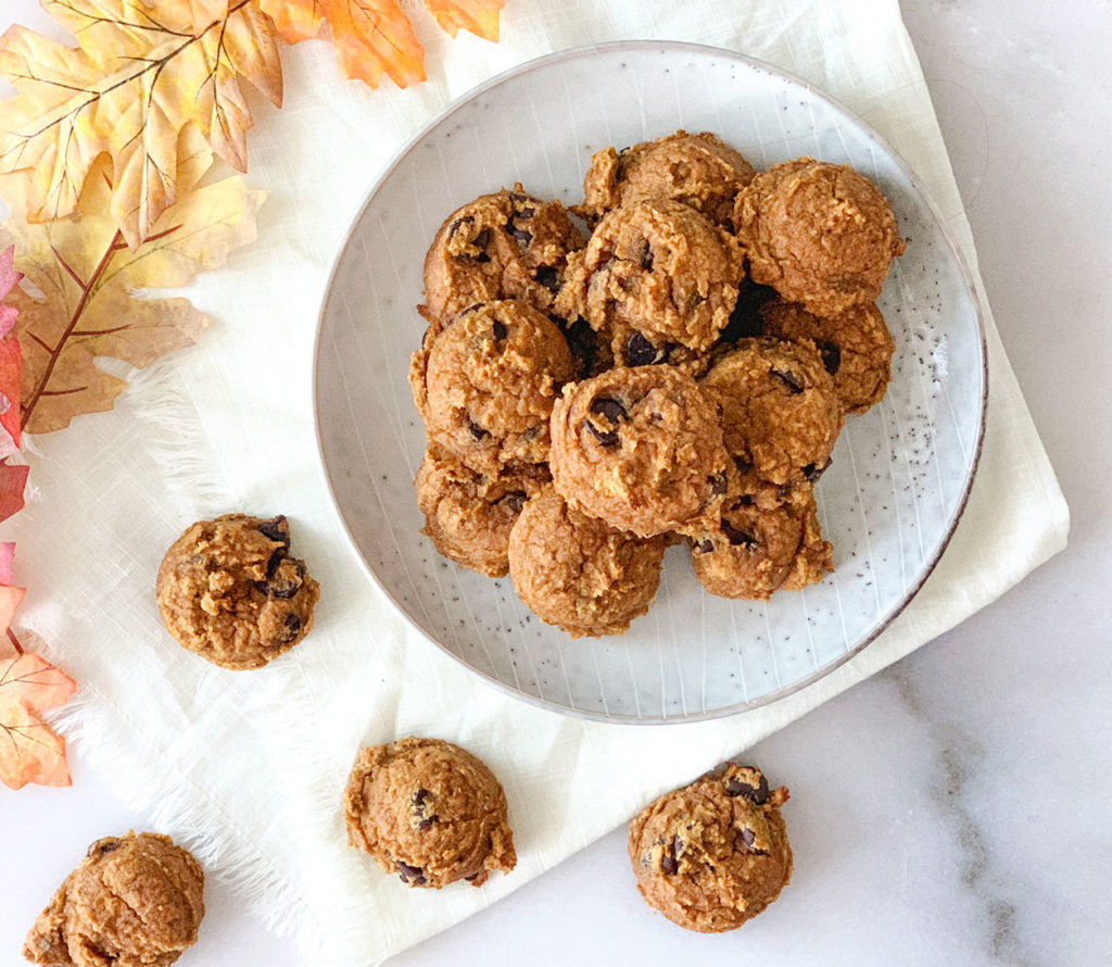 pumpkin cookies stacked on a plate