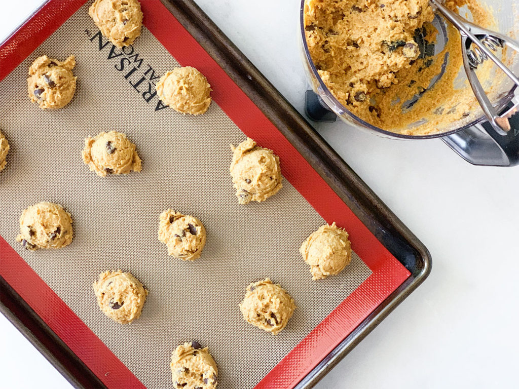 pumpkin cookies formed on a baking sheet