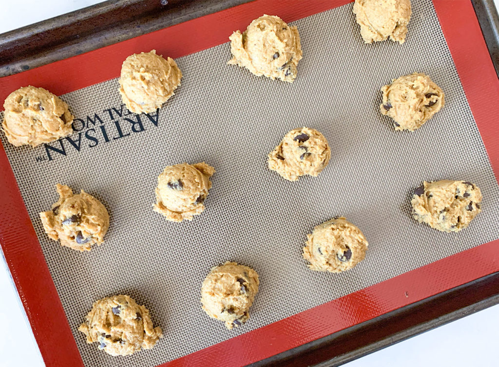 pumpkin cookies formed on a baking sheet