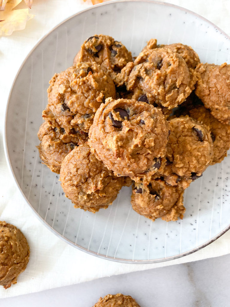 pumpkin cookies stacked on a plate