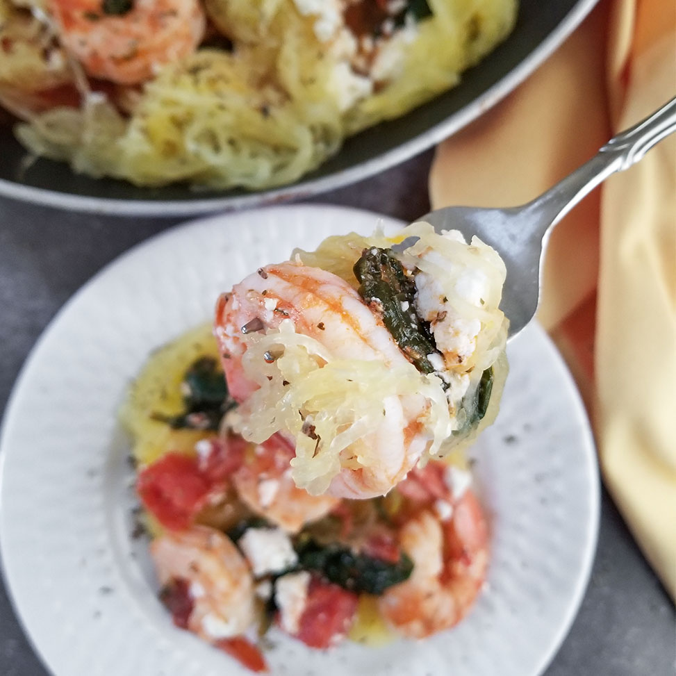 Mediterranean Spaghetti Squash with Shrimp on a plate and on a fork